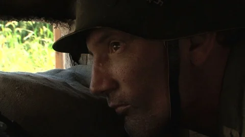 WW2 Recreation - German Soldier in Bunker watches for Grenade attackers Stock Footage 105691353