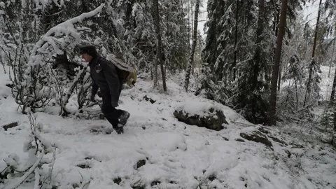 Wwalking on a steep snowy hill, up and down. Stock Footage