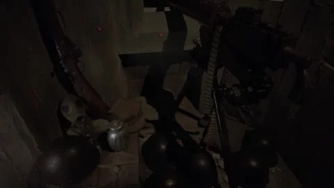 WWII-era machine guns with ammo belt displayed in a Schindler Factory bunker Stock Footage 337046832