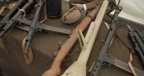 WWII firearms and artifacts on display: Sten guns, Panzerfaust, and gear. Stock Footage 314000640