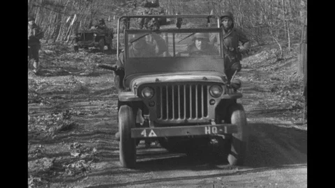 WWII GI runs after jeep, near front lines, Europe 1944. Stock Footage