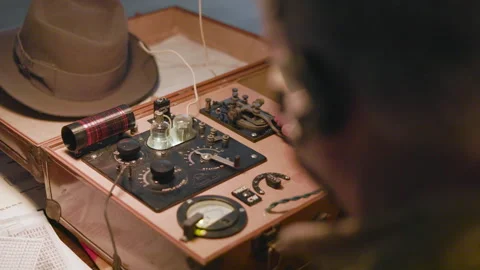 WWII spy sending Morse code messages with his suitcase transmitter Stock Footage 338203677
