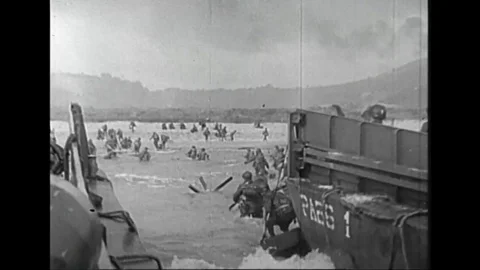 WWII US - Soldiers land at beach in Normandy at D-Day Stock Footage