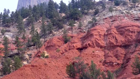 Wyoming, Devils Tower  A red rock formations underneath Devils Tower with tr Stock-Footage 160567727