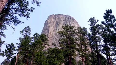 Wyoming, Devils Tower A view of Devils Tower with several trees at its botto Stock Footage 160565117