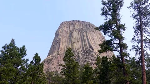 Wyoming, Devils Tower  A zoon in on Devils Tower with several trees all arou Stock Footage 160565808