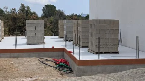 X-default Pallets of concrete blocks stacked on a new insulated floor slab .. Stock Photos