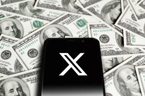 X logo on smartphone screen on background of dollars. Astana, Kazakhstan - June Stock Photos
