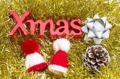 X-mas text and pine cone, fur hat, ribbon on christmas decoration Foto stock