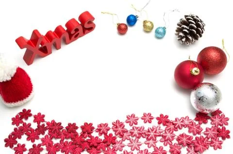 X-mas text and  pine cone, ball, fur hat, red snow flower decoration on white Stock-Fotos