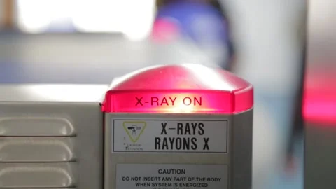 X-Ray light flashes ON and OFF as Passengers Bags Pass Security Stock Footage 219195146