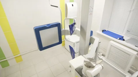 X-ray machine stands in clean clinic room with tiled floor Stock Footage 312403593