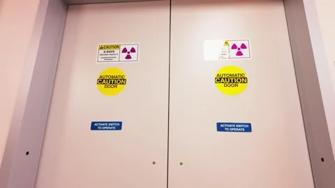 X-ray room automatic doors with radiation hazard warning signs Stock Footage 331710975