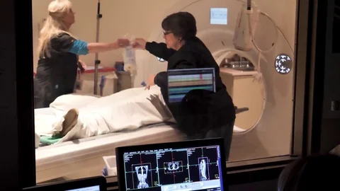 X-Ray staff prepare to remove patient from CT scanner following diagnostic scan Stock Footage 81036469
