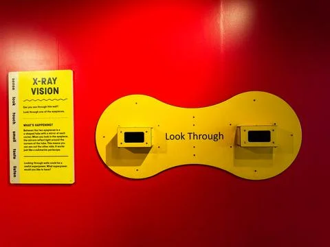X ray vision interactive look through exhibit on yellow display panel mount.. Stock Photos