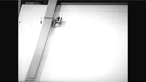 An X-Y plotter is used and a physics teacher distributes copies of a plot and Vídeos de archivo 92631887