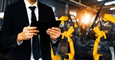 XAI Engineer use advanced robotic software to control industry robot arm in Stockfoto's