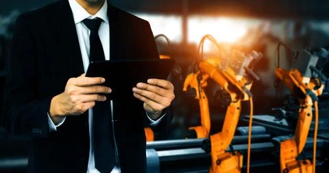 XAI Engineer use advanced robotic software to control industry robot arm in Stock Photos