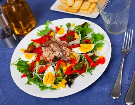 Xato salad with cod, chopped eggs and corn Stock Photos