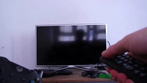 Xbox One video game controller on one hand and turning on television Stock Footage 151924391