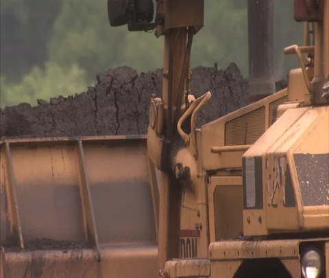 XCU coal being pushed out of bulldozer scoop. Stock Footage 86694381