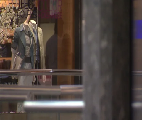 XCU glass elevator rises into frame, with women's boutique in background Stock Footage 86748492