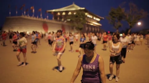 Xi'an, China - Jul 13, 2016. people sing and dance at night. Daming palce Plaza Stock Footage 106876017