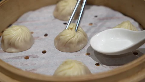 Xiao long bao soup dumpling buns with chopsticks in restaurant Stock Footage 282720141