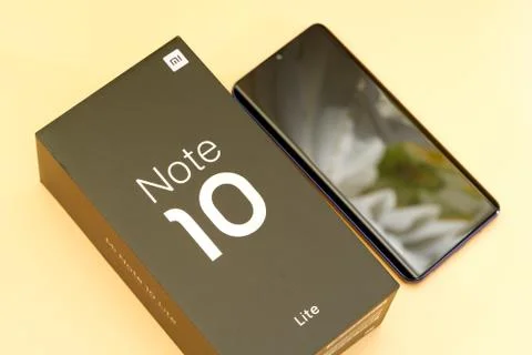 Xiaomi mi note 10 lite new phone and box, black on peach colored background Stock Photos