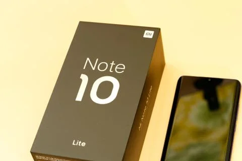 Xiaomi mi note 10 lite new phone box, black on peach colored background Stock Photos