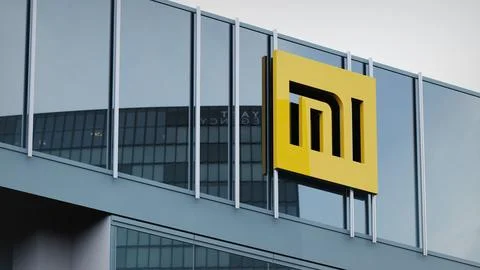 Xiaomi Stock data presented on the logo of the office facade editorial Stock Photos