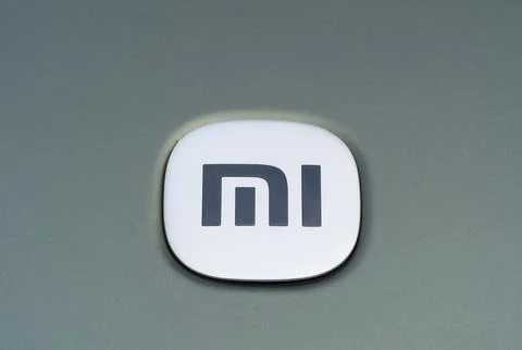 Xiaomi SU 7, close-up of the logo on the hood of a green car. Stock Photos