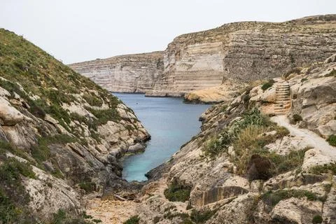Xlendi Bay surrounded by cliffs Stock Photos
