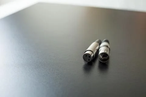 Xlr audio cable on top of a black table. Connections on display. xlr cable co Foto stock