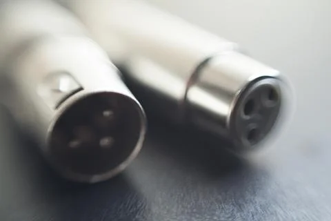 Xlr audio cable on top of a black table. Connections on display. xlr cable co Foto stock