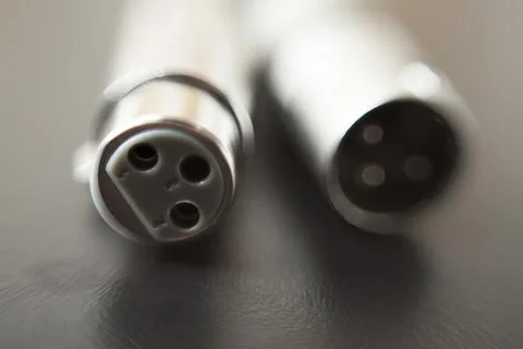 Xlr audio cable on top of a black table. Connections on display. xlr cable co 스톡 사진