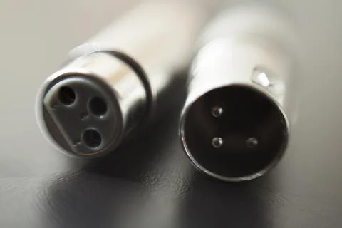 Xlr audio cable on top of a black table. Connections on display. xlr cable co Stock Photos