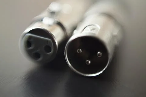 Xlr audio cable on top of a black table. Connections on display. xlr cable co Stock Photos