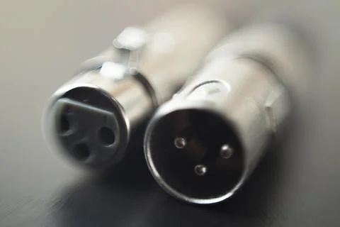 Xlr audio cable on top of a black table. Connections on display. xlr cable co Stock Photos