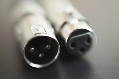 Xlr audio cable on top of a black table. Connections on display. xlr cable co Stock Photos