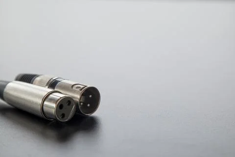 Xlr audio cable on top of a black table. Connections on display. xlr cable co Stock Photos