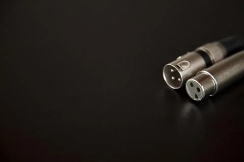 Xlr audio cable on top of a black table. Connections on display. xlr cable co Photos