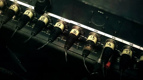 XLR Cables plugged into the back of a mixing console desk, number-coded. Stock-Footage 52056503