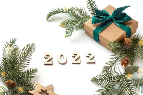 Xmas 2022 composition with present box decorations, wooden snowflakes, fir tree Stock Photos