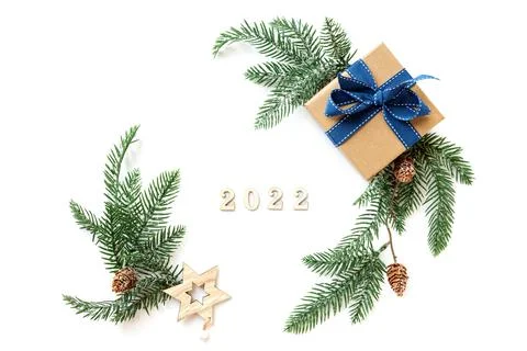 Xmas 2022 composition with present box decorations, wooden snowflakes, fir tree Stock Photos