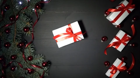 Xmas background with pine branches, baubles, gifts and shimmering lights 스톡 동영상 99062493