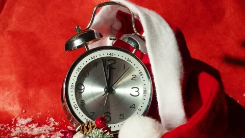 Xmas red hat and alarm clock on red background Video stock 143380862