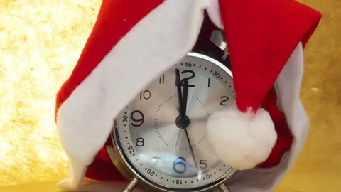 Xmas red hat and alarm clock on red background Stock Footage 143383553