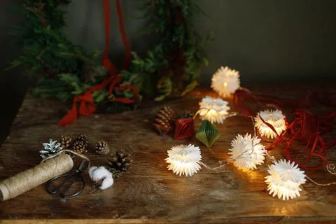 Xmas workshop workspace with thread, scissors, pine cones and warm lights Stock Photos