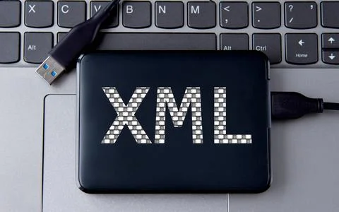 XML - acronum on an external drive in gray letters on the background of a l.. Stock Photos